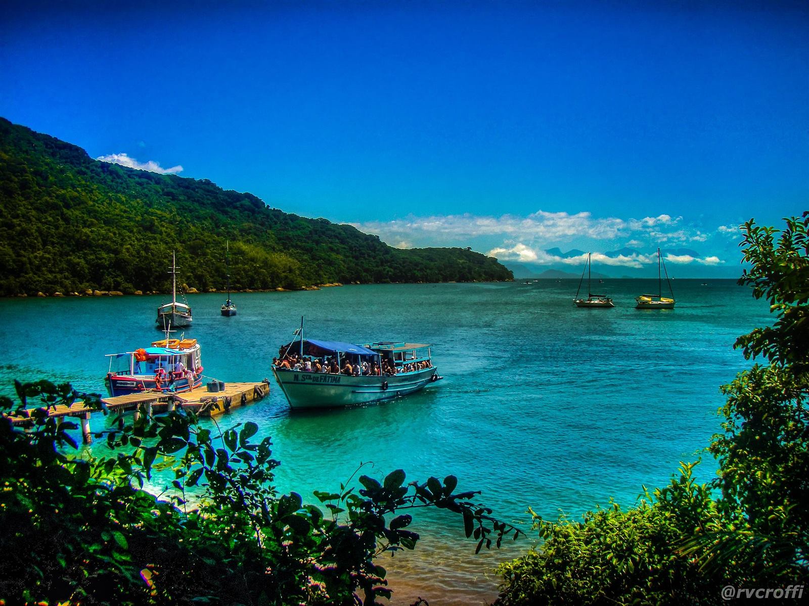 Turquoise bay of Ilha Grande with boats at the pier