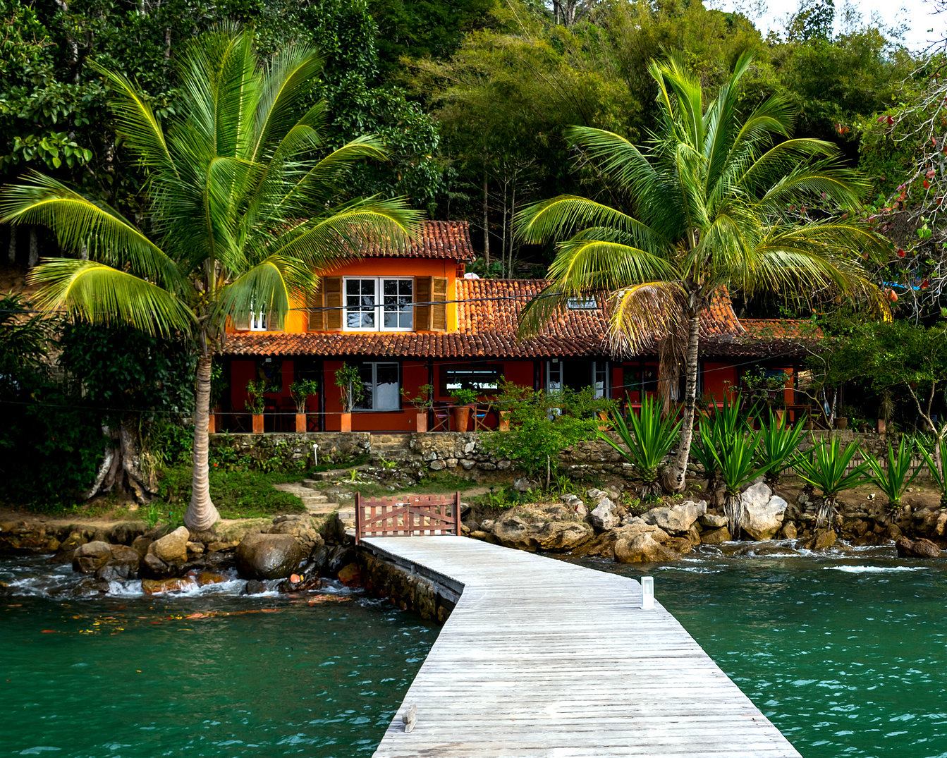 Traditional house and wooden pier at the water's edge on Ilha Grande